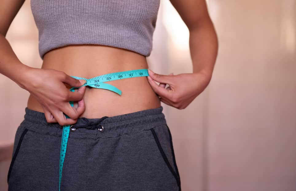 woman measuring waist